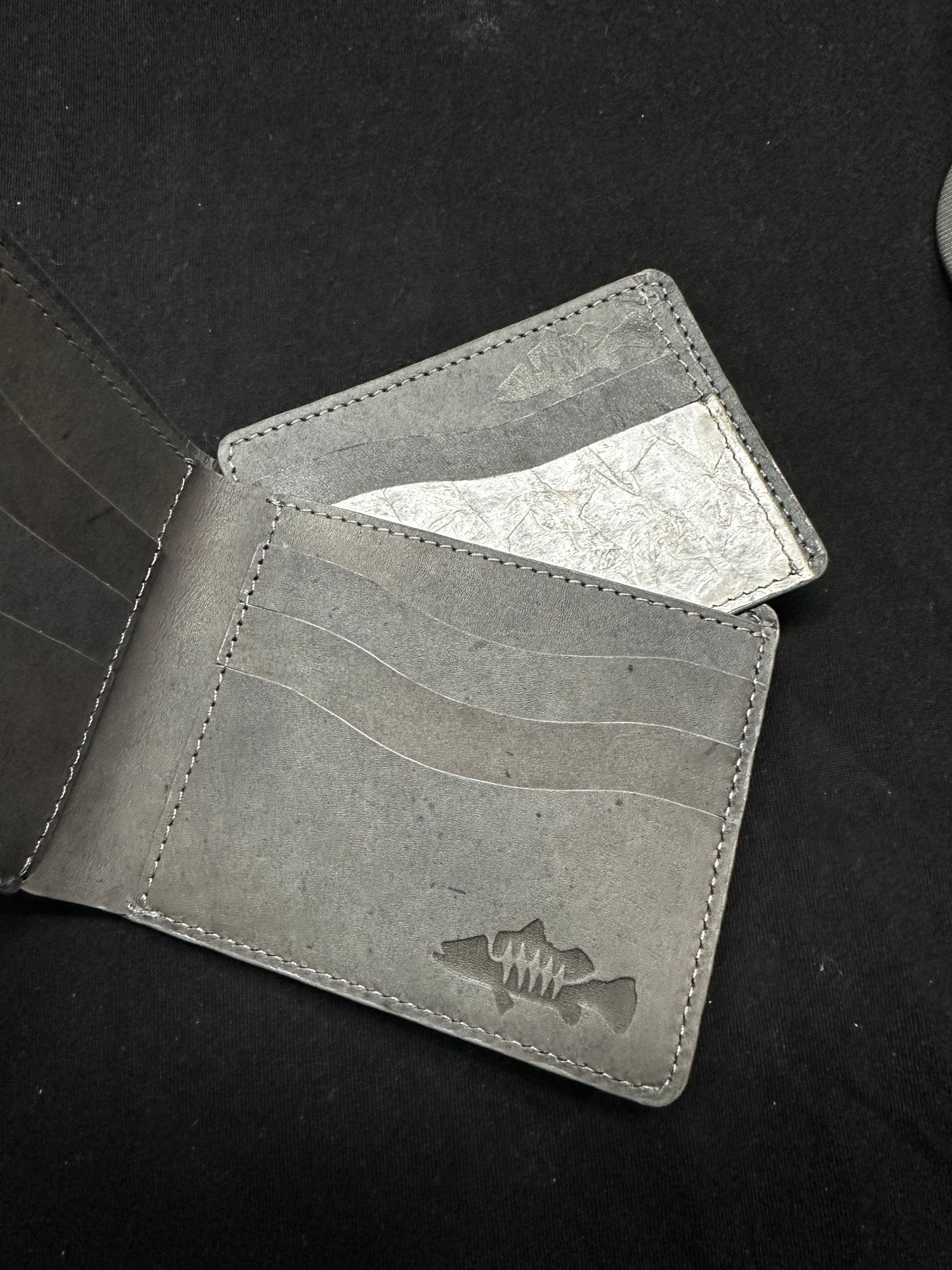 Gray barramundi leather card holder and bifold wallet with multiple card slots and a subtle embossed logo, showing how they work together.