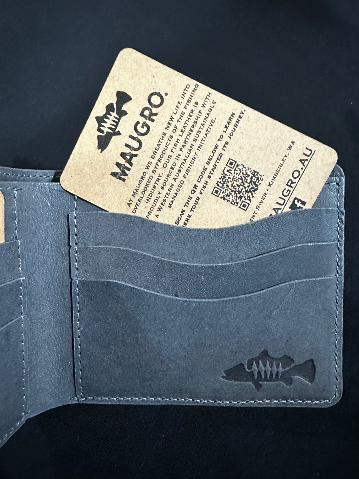 Maugro Denim wallet with a fish tracker location card on a black background
