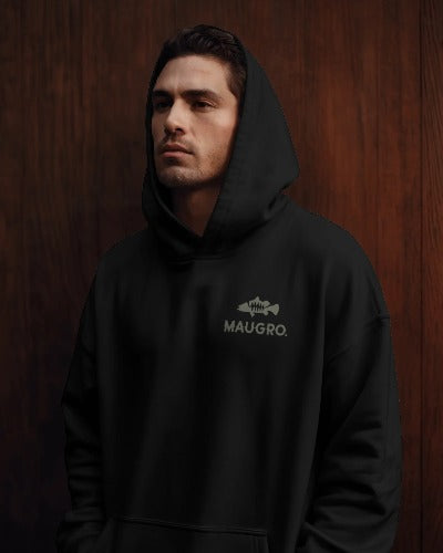 Black unisex hoodie with front kangaroo pocket and MAUGRO logo on chest, worn with hood up.