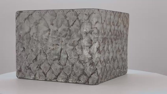 Barramundi skin wallet on a white background, green leather interior - video