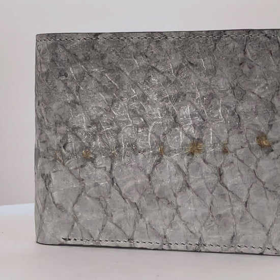 Barramundi skin wallet on a white background, denim leather interior - video