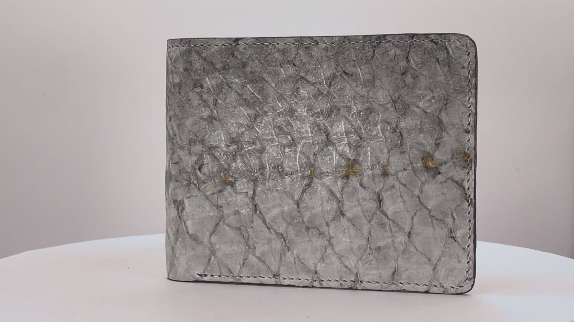 Barramundi skin wallet on a white background, denim leather interior - video
