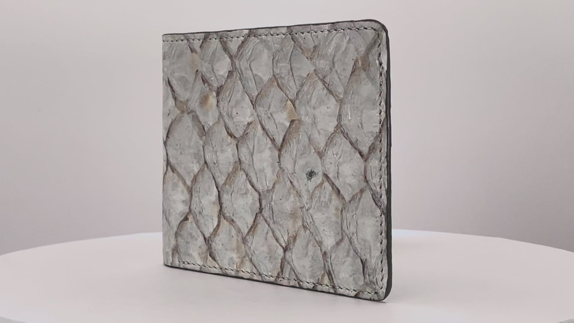 Barramundi skin wallet on a white background, denim leather interior - video
