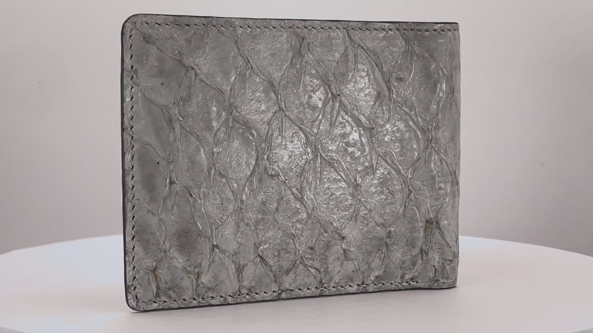 Barramundi skin wallet on a white background, denim leather interior - video