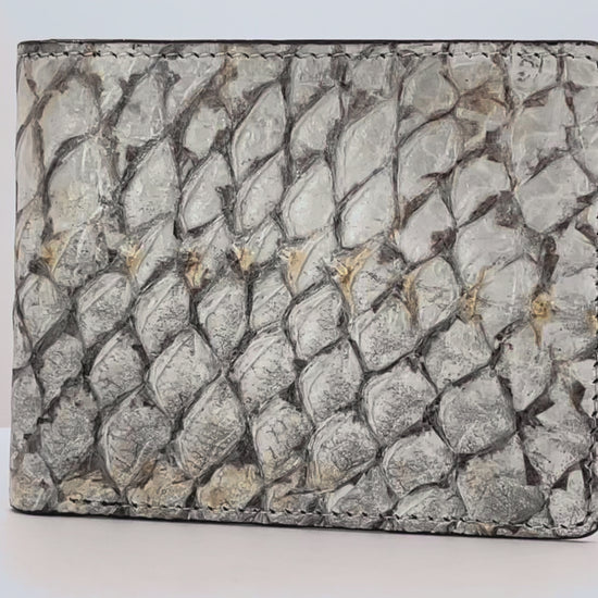Barramundi skin wallet on a white background, black leather interior