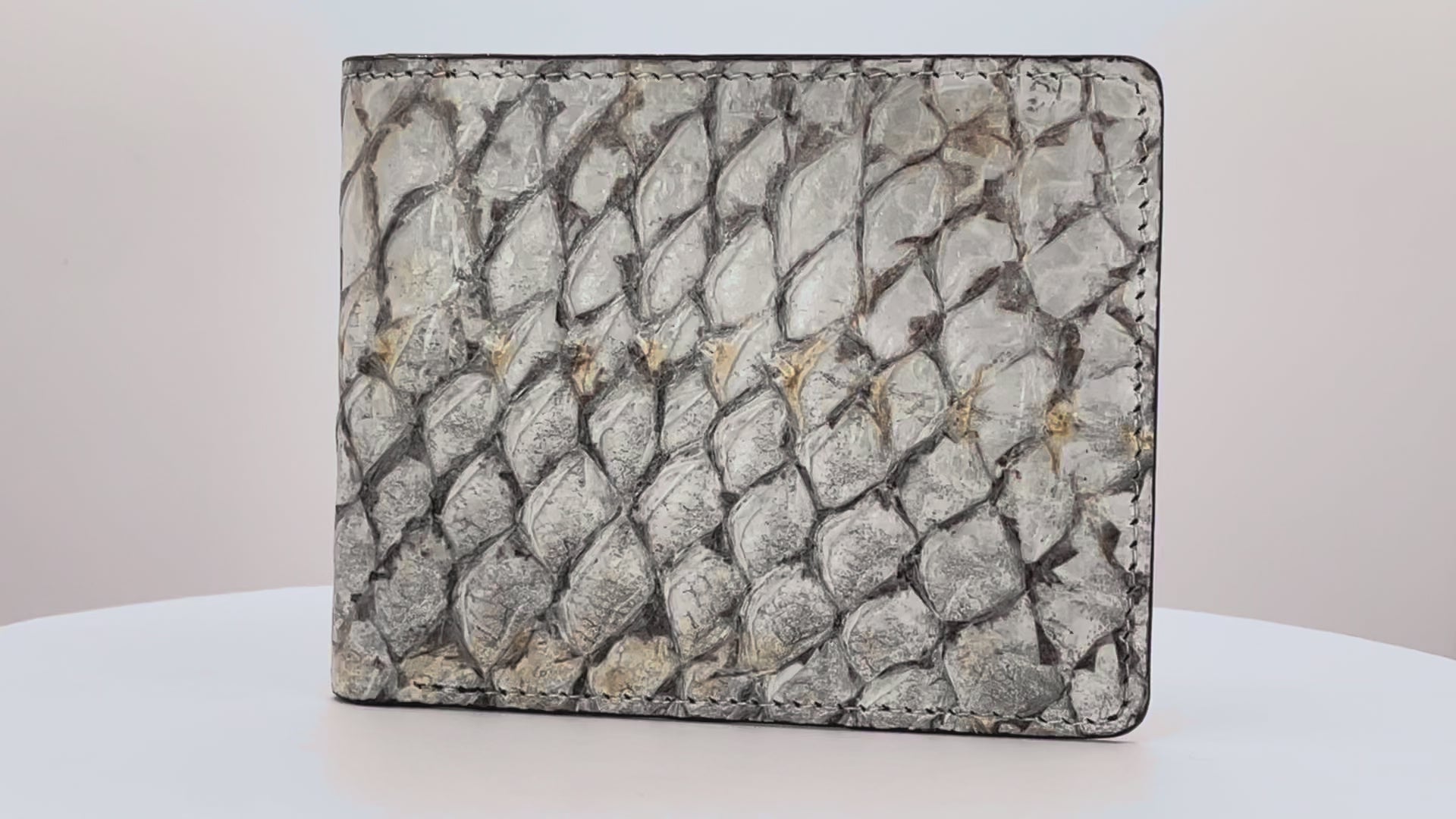 Barramundi skin wallet on a white background, black leather interior