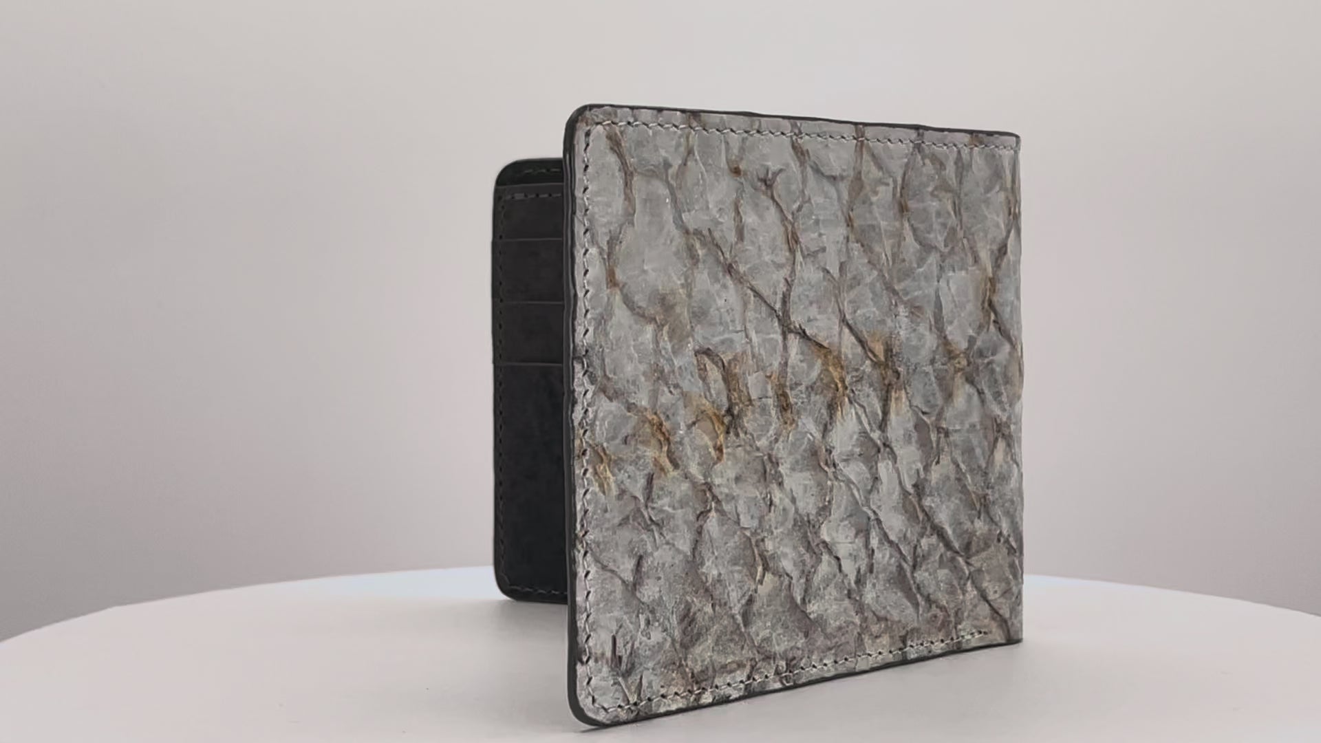 Barramundi skin wallet on a white background, denim leather interior - video