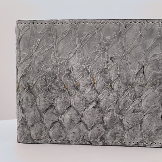 Barramundi skin wallet on a white background, denim leather interior