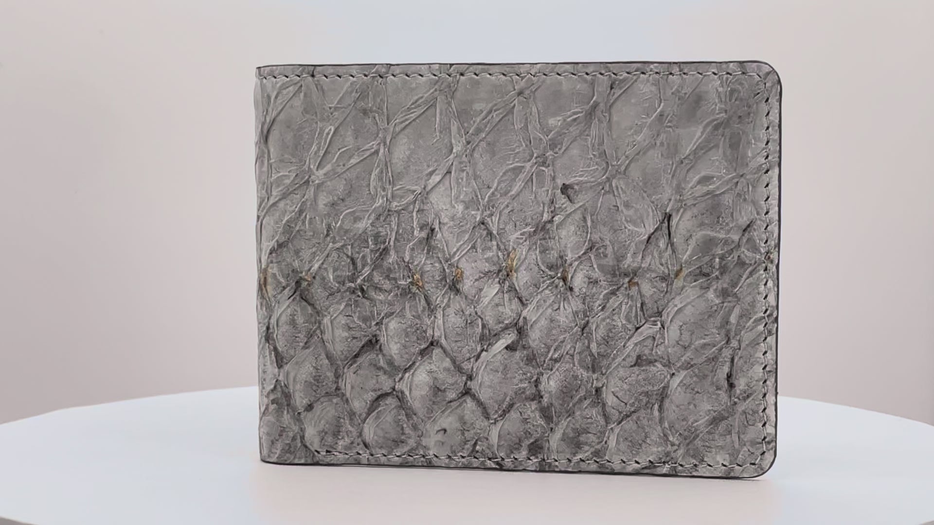 Barramundi skin wallet on a white background, denim leather interior