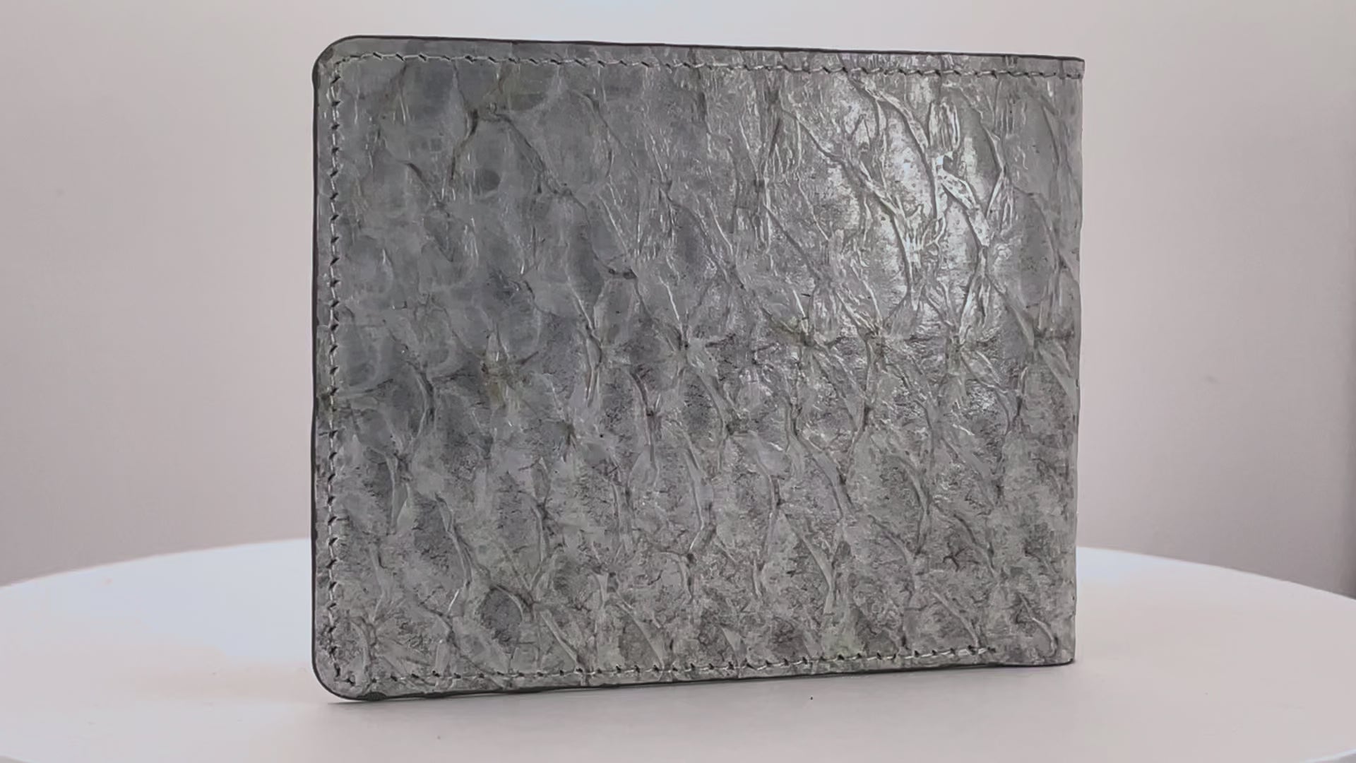 Barramundi skin wallet on a white background, denim leather interior - video