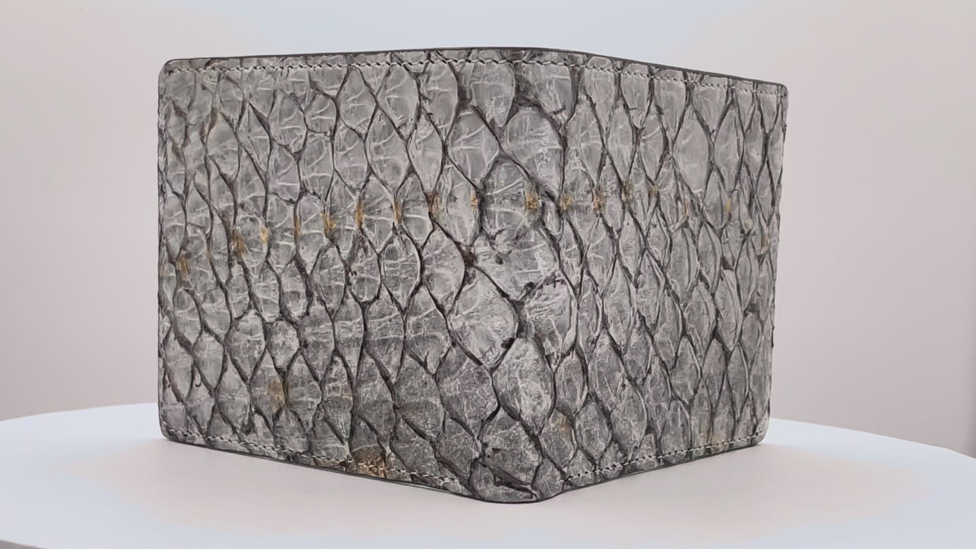 Barramundi skin wallet on a white background, denim leather interior - video