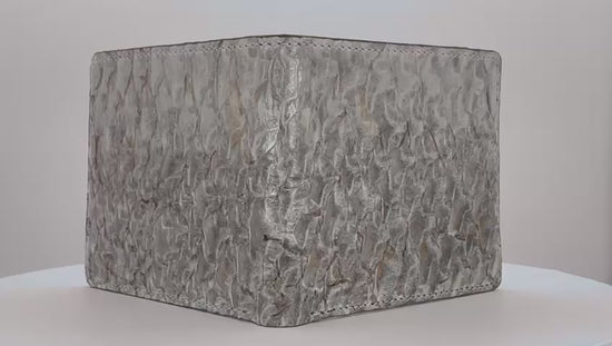 Barramundi skin wallet on a white background, green leather interior - video