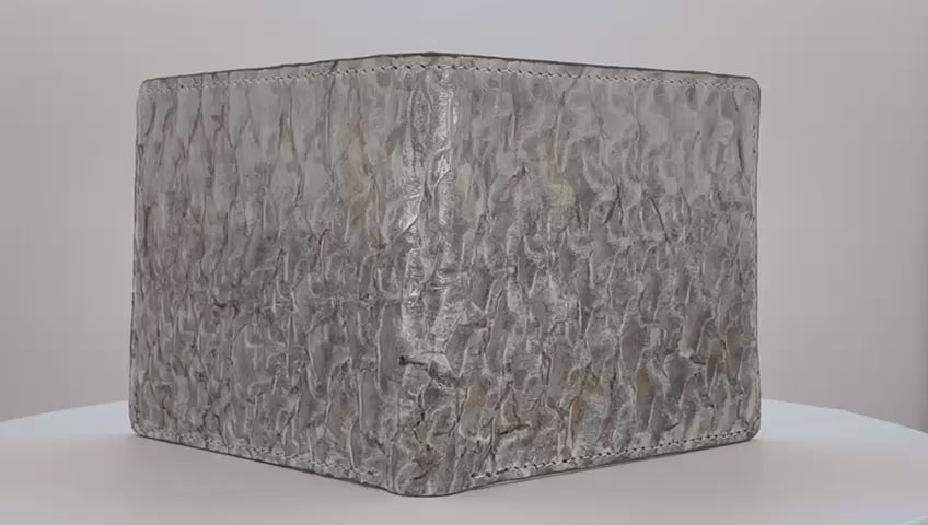 Barramundi skin wallet on a white background, green leather interior - video