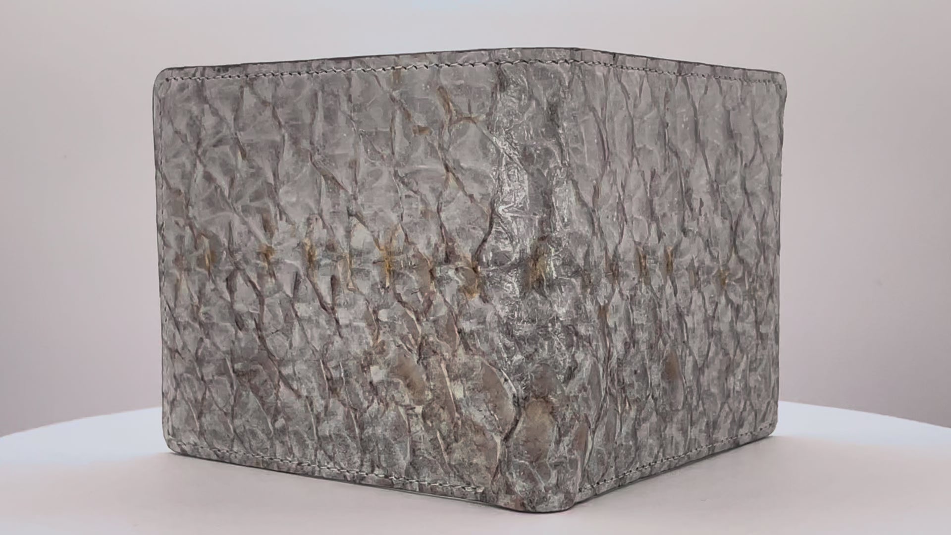 Barramundi skin wallet on a white background, denim leather interior - video