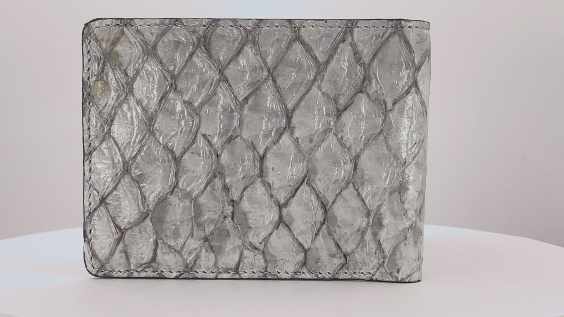 Barramundi skin wallet on a white background, denim leather interior - video
