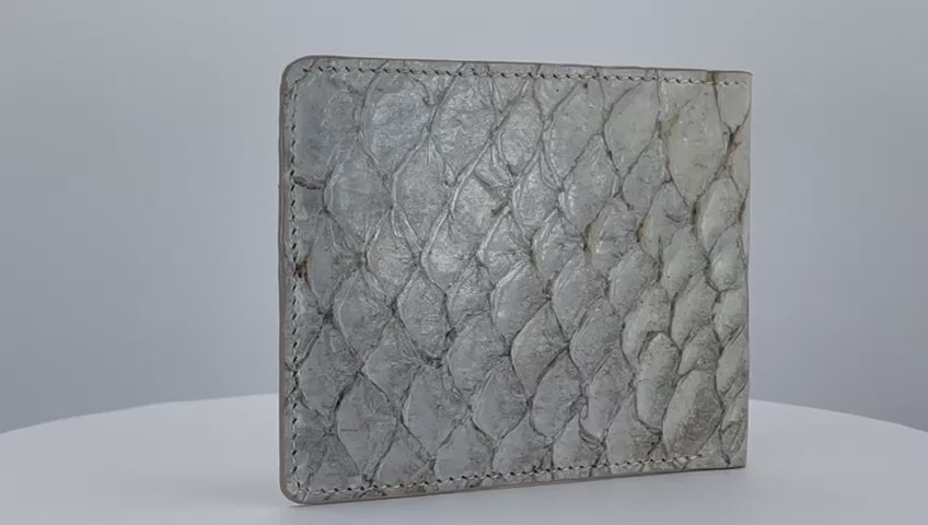 Barramundi skin wallet on a white background, brown leather interior - video