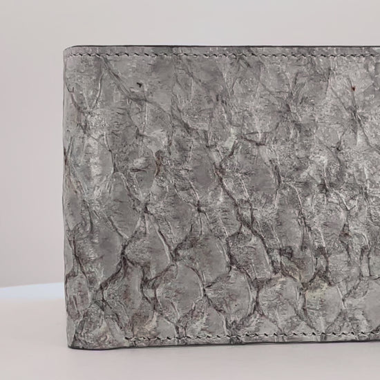 Barramundi skin wallet on a white background, denim leather interior - video