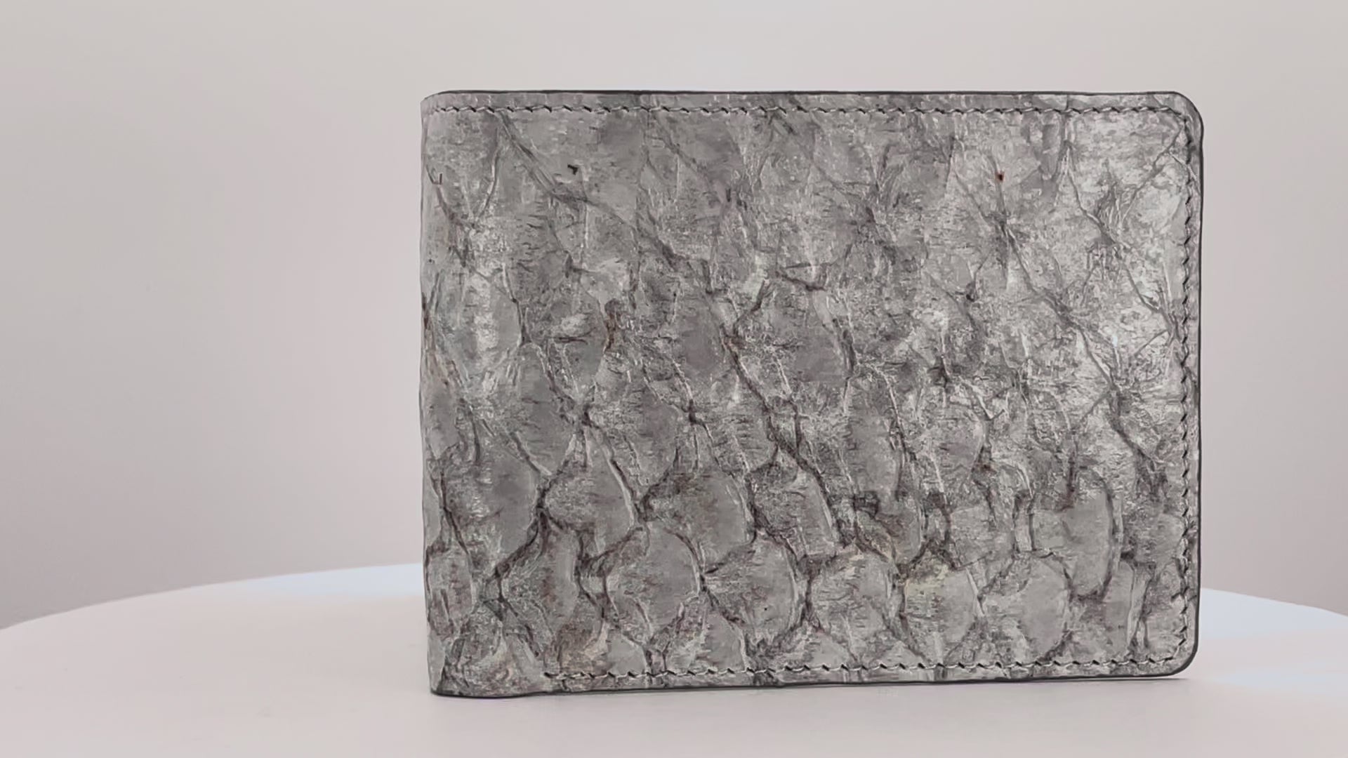 Barramundi skin wallet on a white background, denim leather interior - video