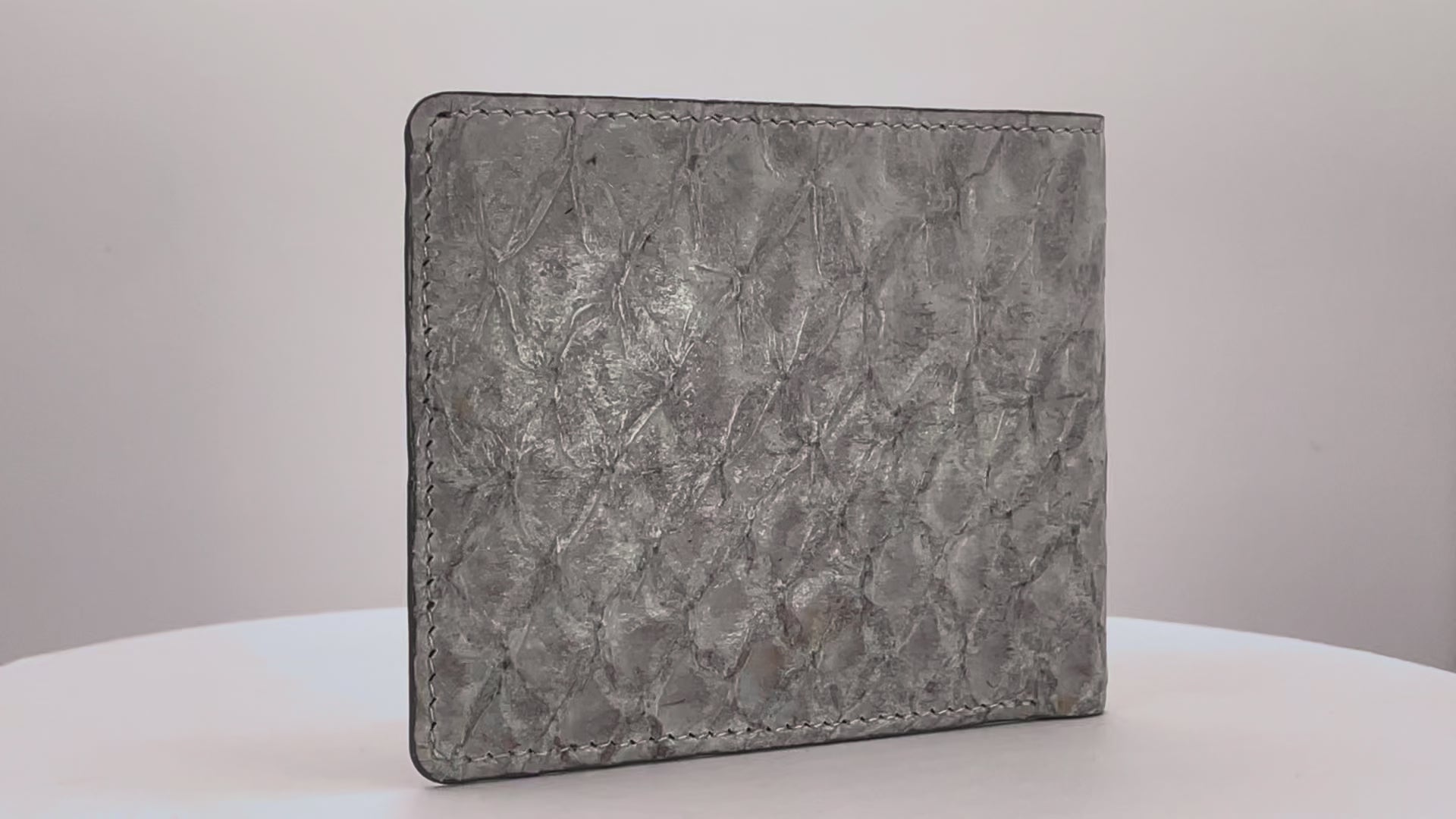 Barramundi skin wallet on a white background, denim leather interior - video