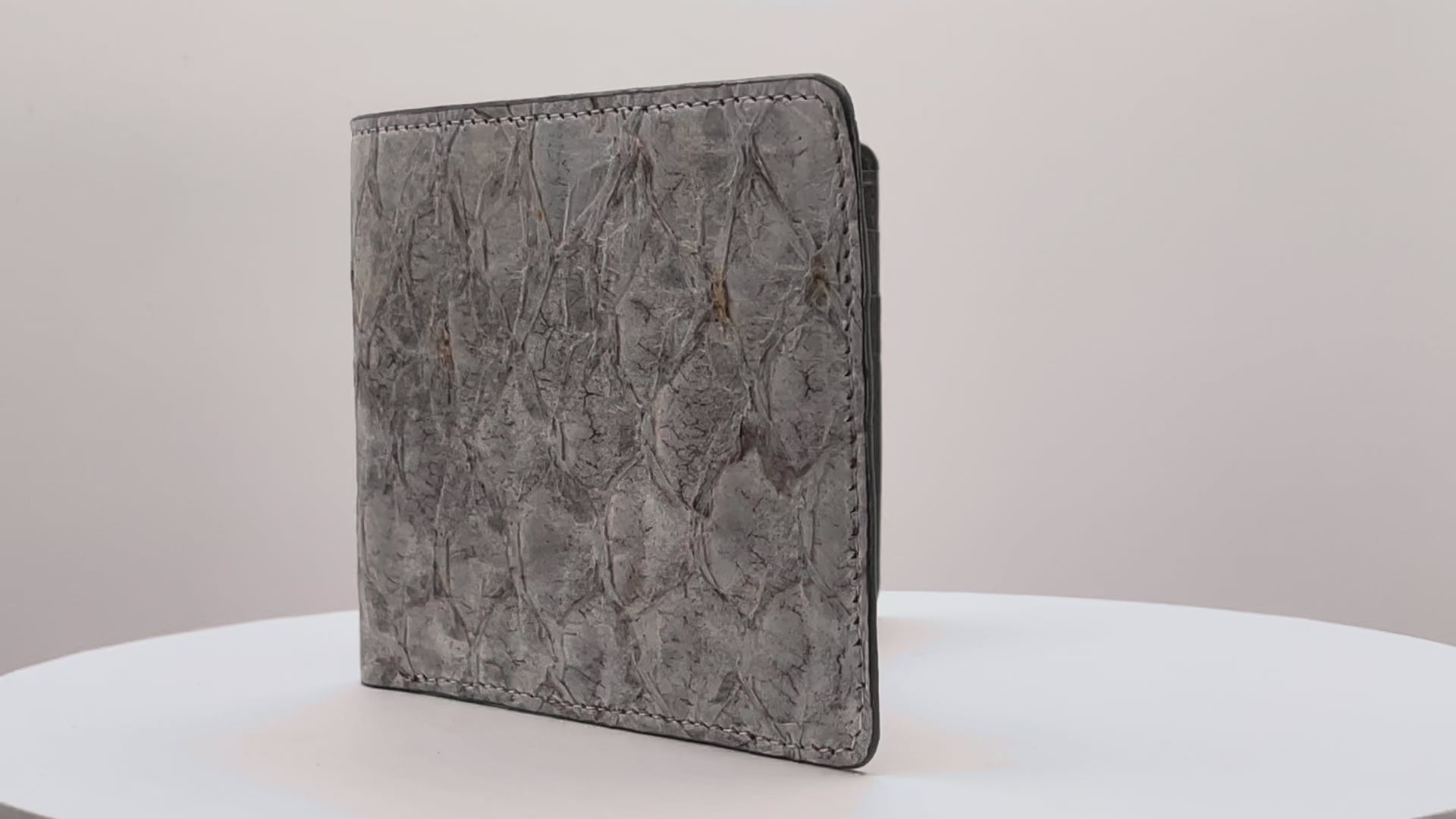 Barramundi skin wallet on a white background, denim leather interior - video
