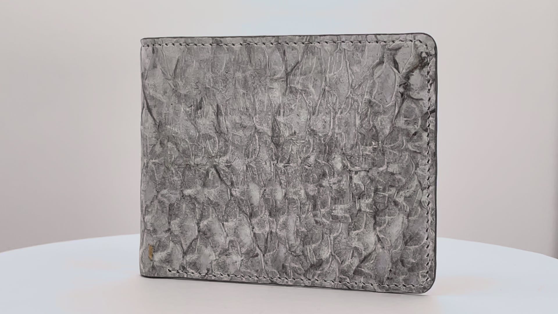Barramundi skin wallet on a white background, denim leather interior