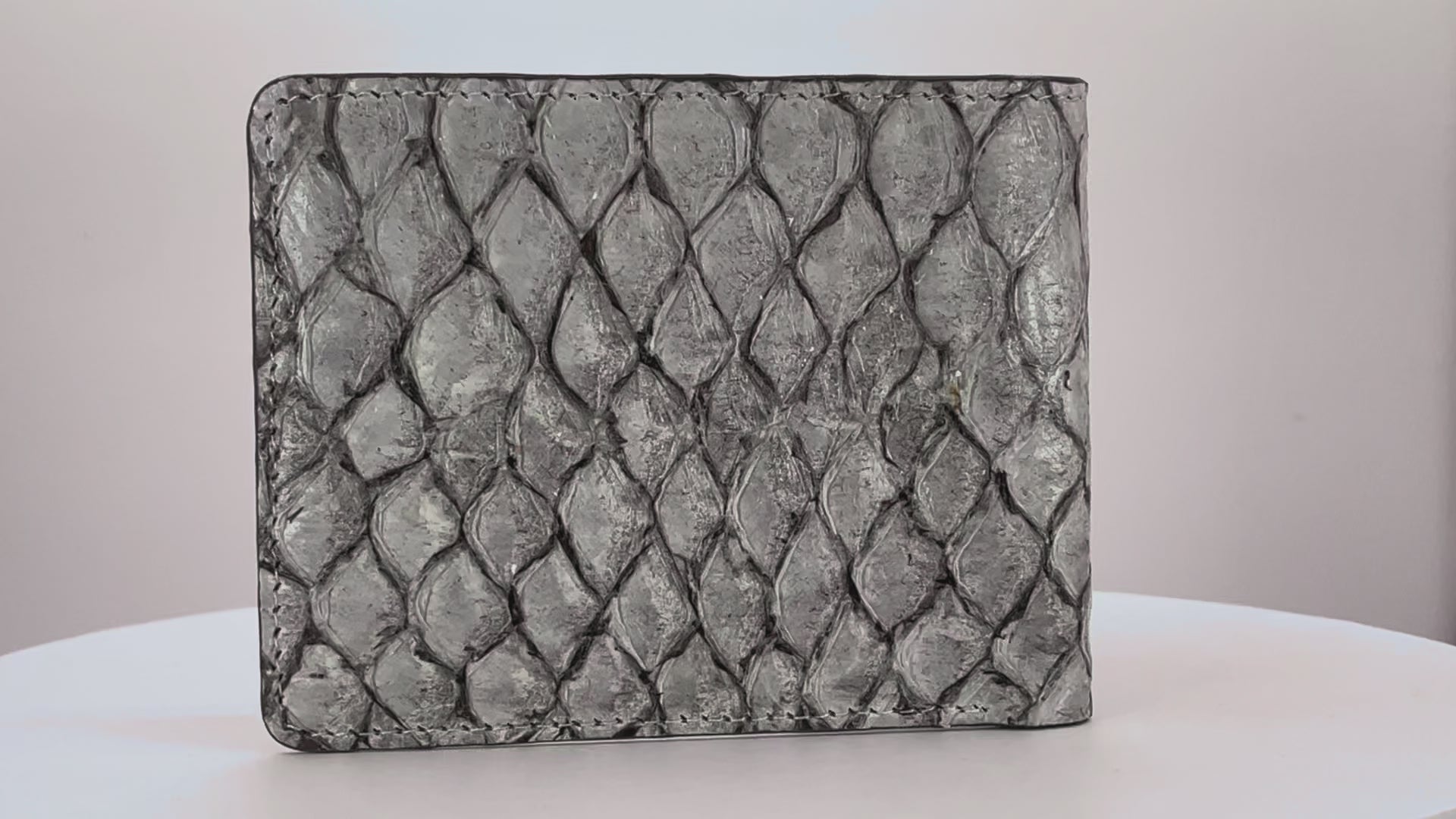 Barramundi skin wallet on a white background, denim leather interior - video