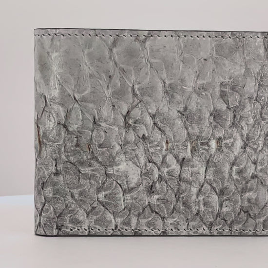 Barramundi skin wallet on a white background, denim leather interior - video