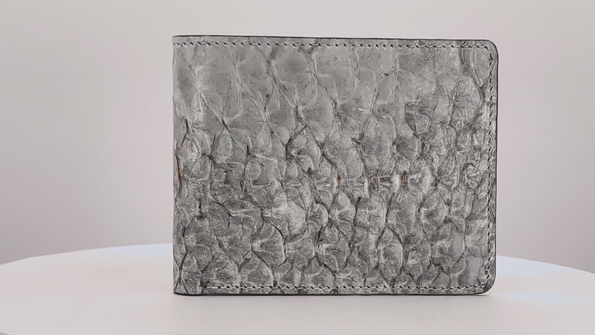 Barramundi skin wallet on a white background, denim leather interior - video