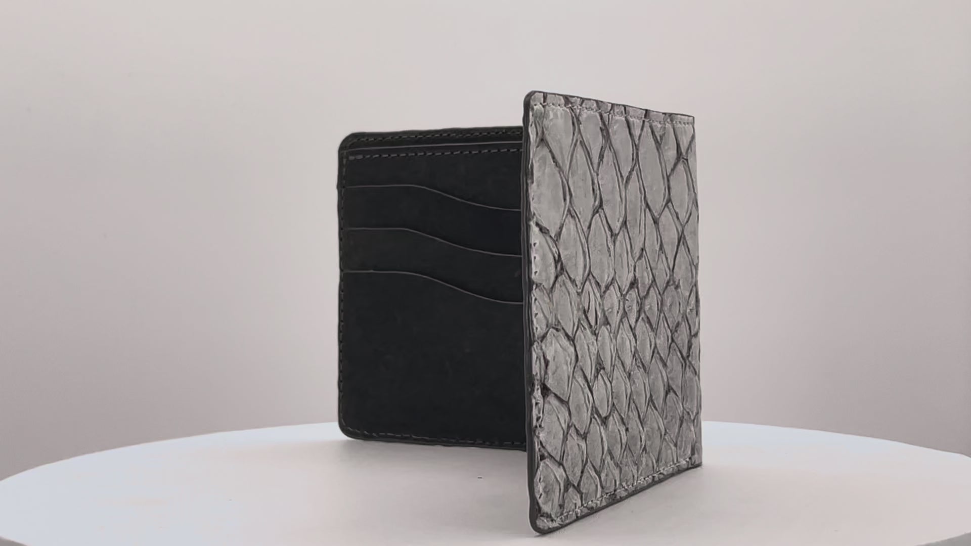 Barramundi skin wallet on a white background, denim leather interior