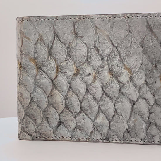 Barramundi skin wallet on a white background, brown leather interior - video