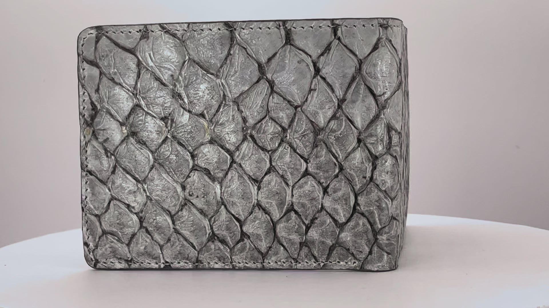 Barramundi skin wallet on a white background, denim leather interior