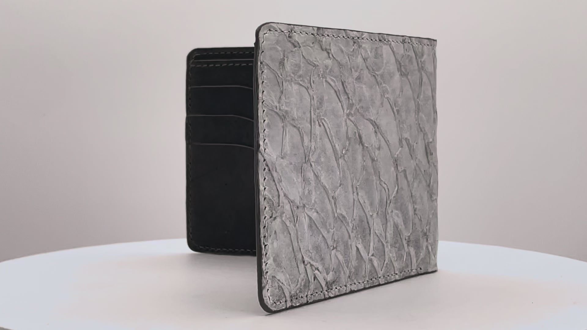 Barramundi skin wallet on a white background, denim leather interior - video