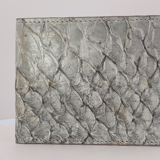 Barramundi skin wallet on a white background, brown leather interior - video