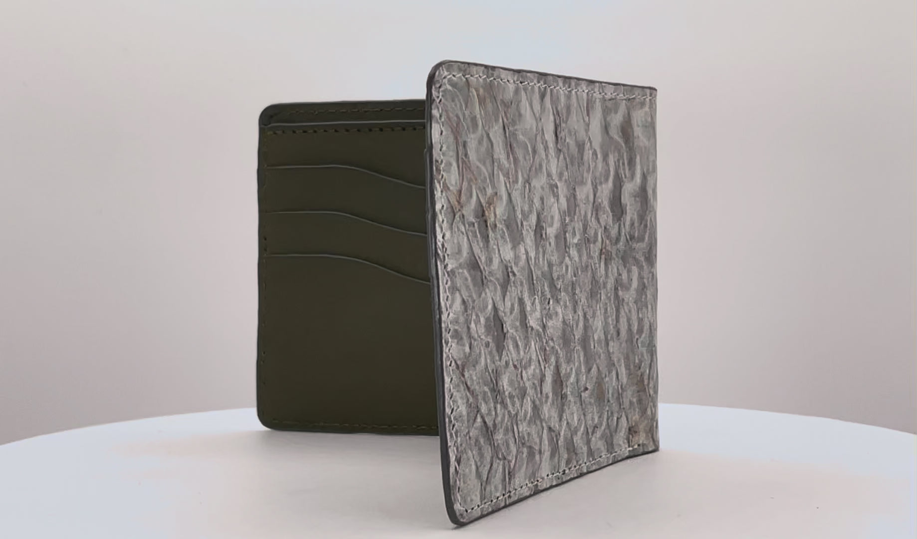 Barramundi skin wallet on a white background, green leather interior - video 