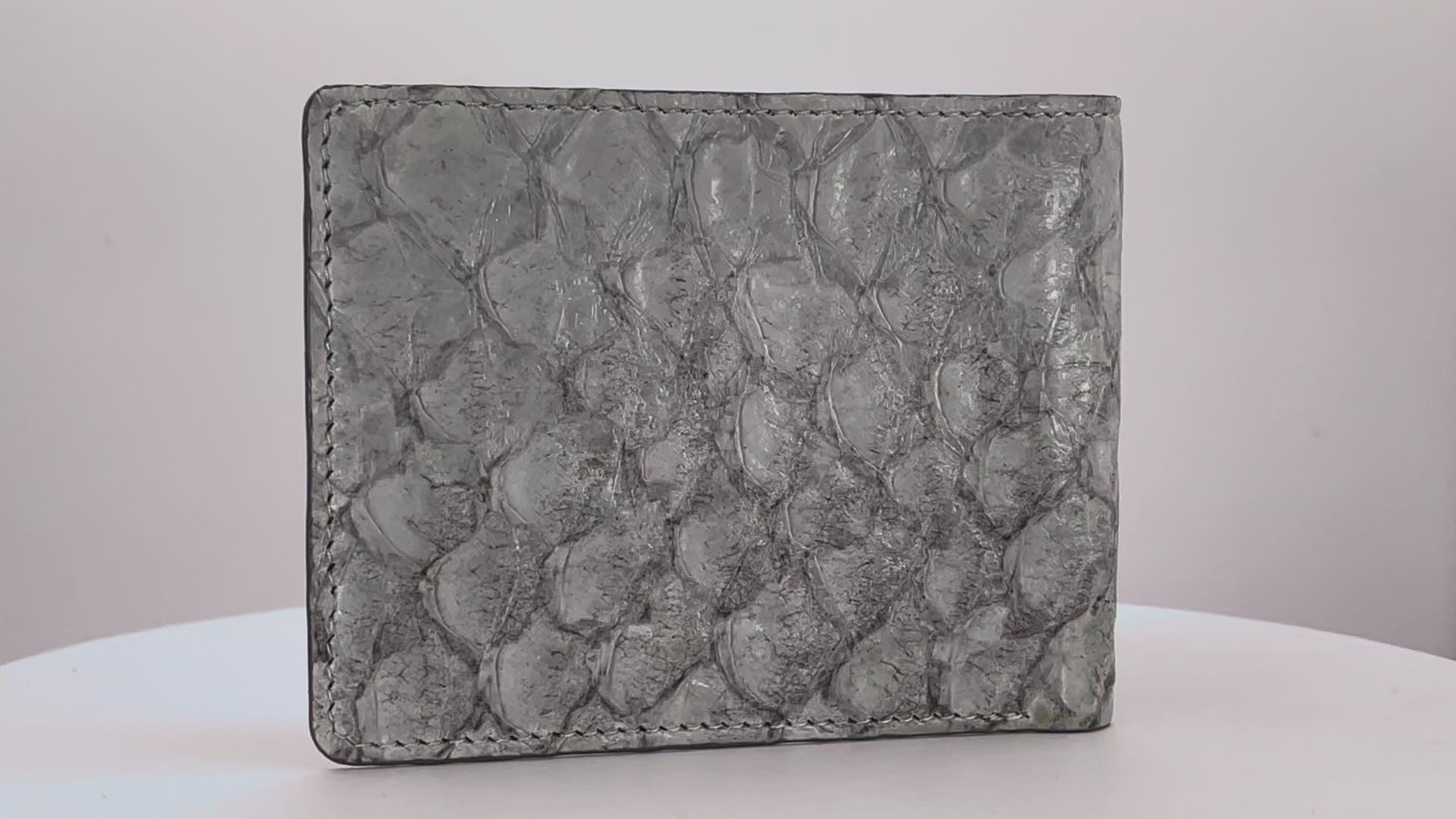Barramundi skin wallet on a white background, denim leather interior - video